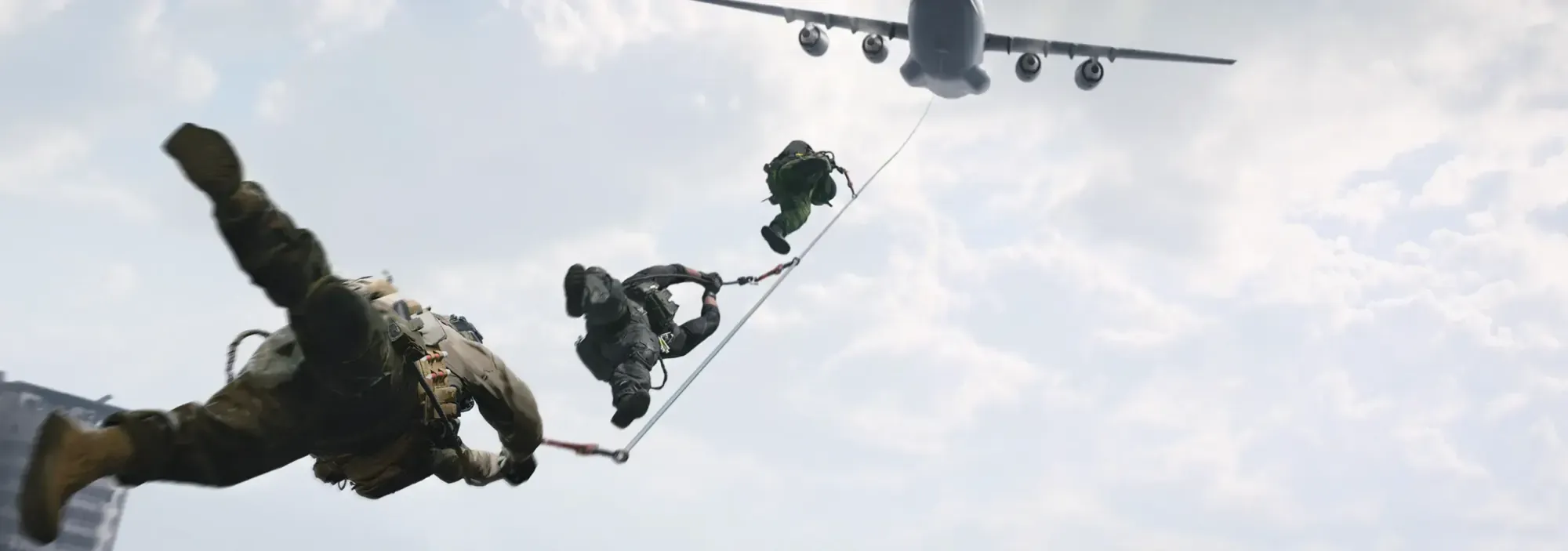 Two operators fast-roping from the rear ramp of a transport aircraft