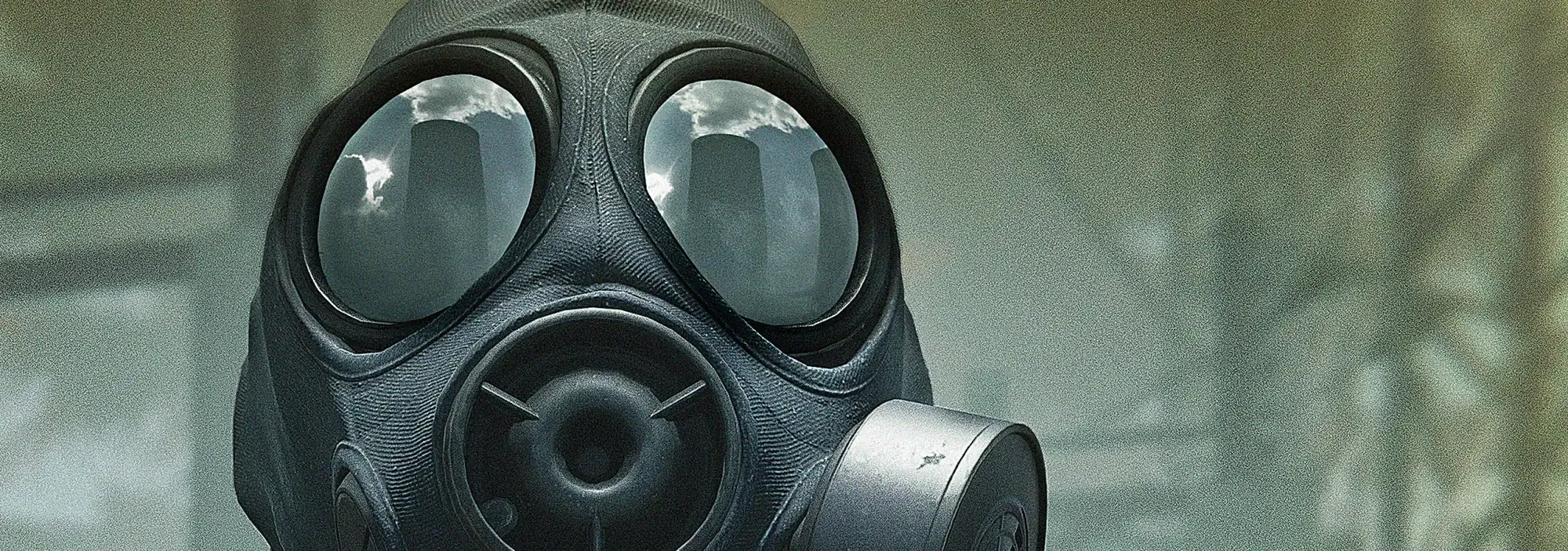 Close-up of an operator in a gas mask, a city skyline reflected in the lenses